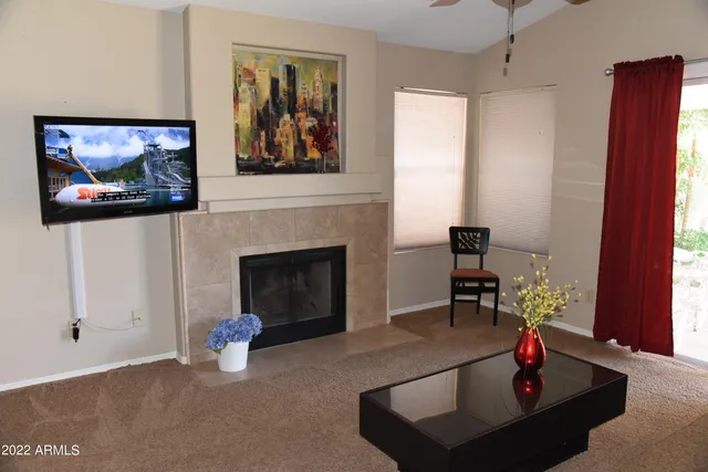 a living room with furniture and a fireplace