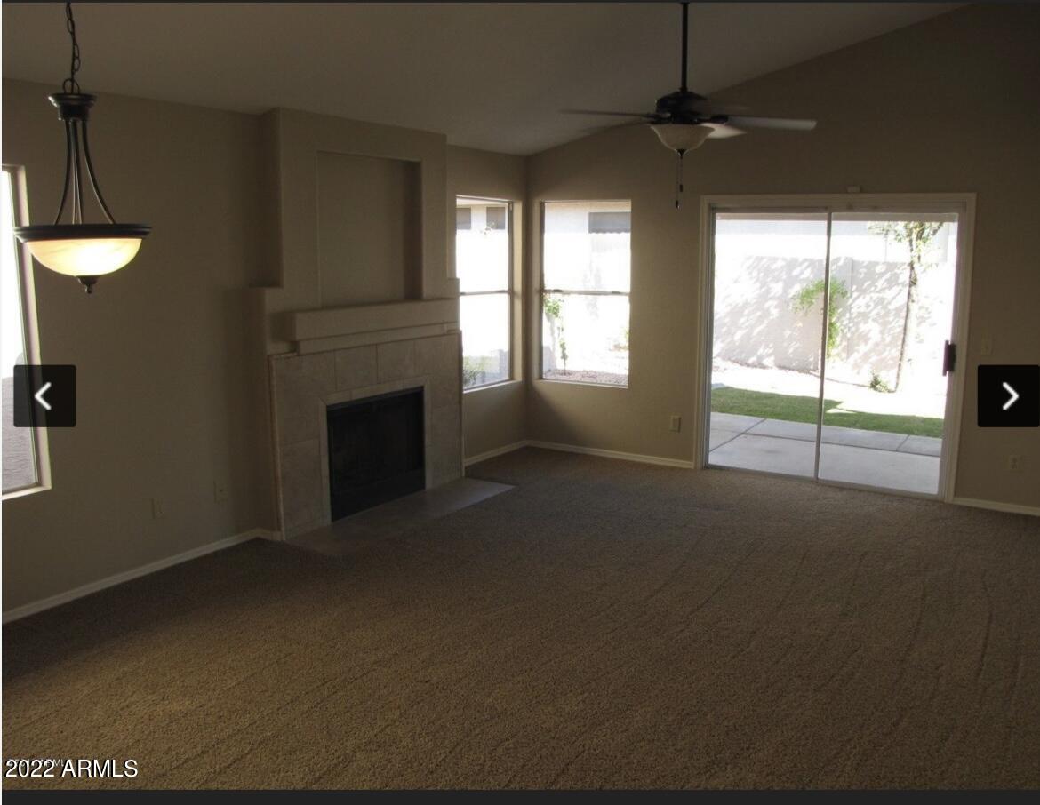 1690 East Gary Drive Chandler, AZ 85225 - Photo 5 of 17 a view of an empty room with a fireplace and a window