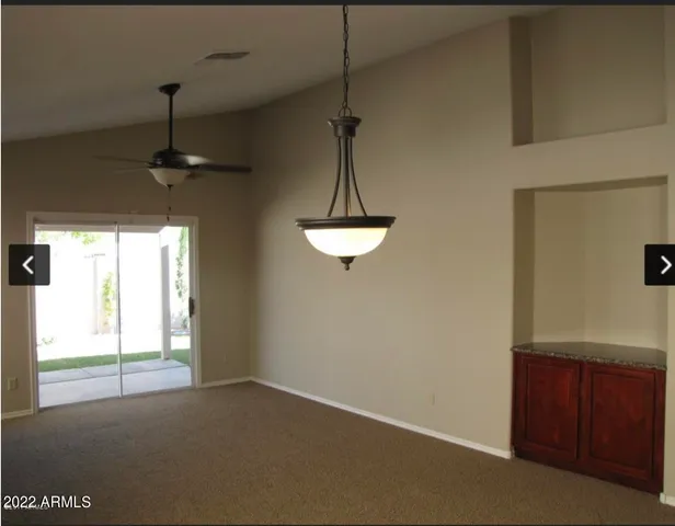 a dining room with a window and a chandelier