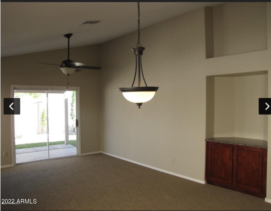1690 East Gary Drive Chandler, AZ 85225 - Photo 6 of 17 a dining room with a window and a chandelier