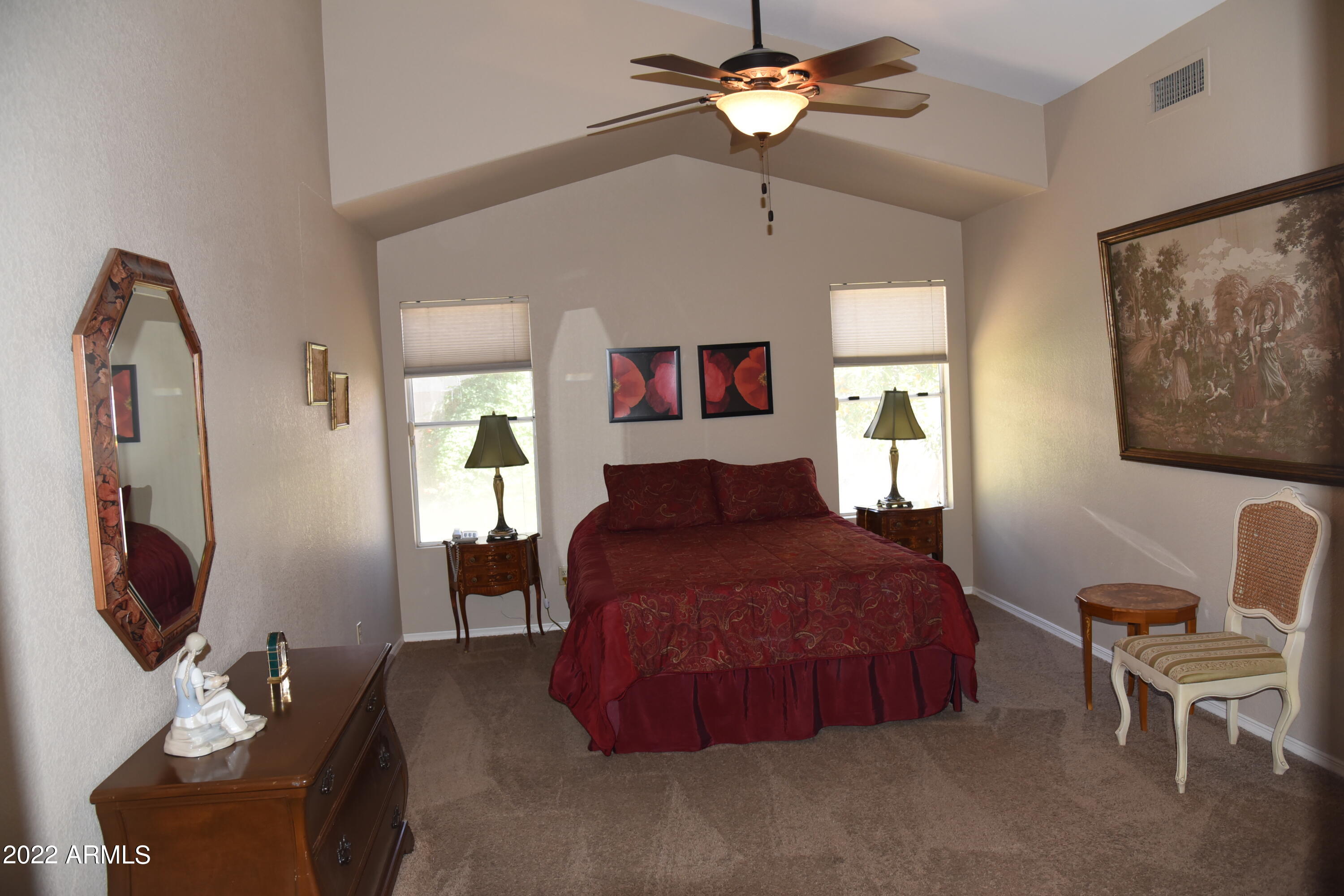 1690 East Gary Drive Chandler, AZ 85225 - Photo 7 of 17 a spacious bedroom with a bed mirror furniture and a flat screen tv