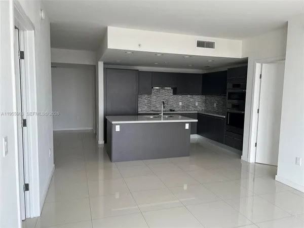 a kitchen with stainless steel appliances a sink and cabinets