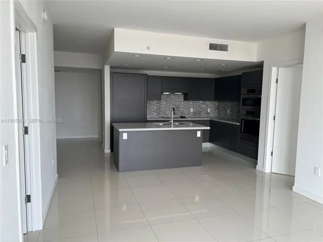 a kitchen with stainless steel appliances a sink and cabinets