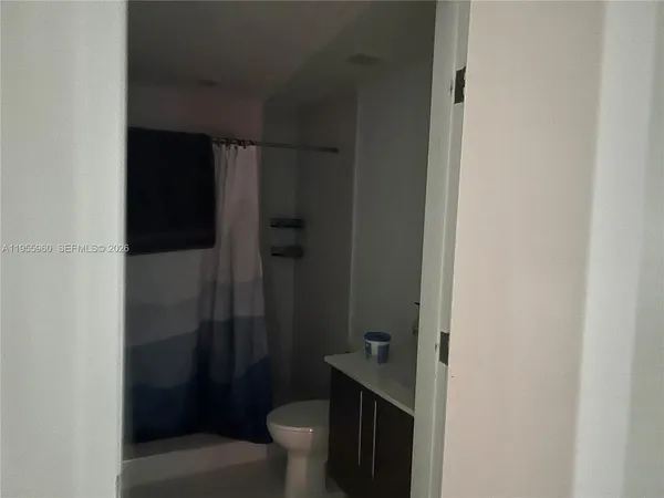 a bathroom with a toilet and a shower