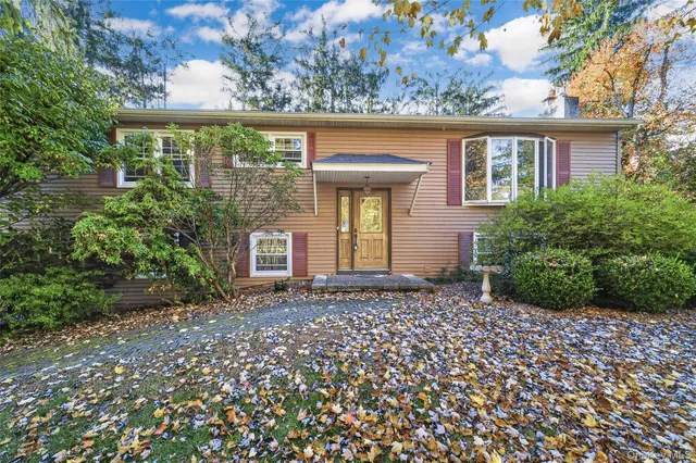 front view of a house with a bench