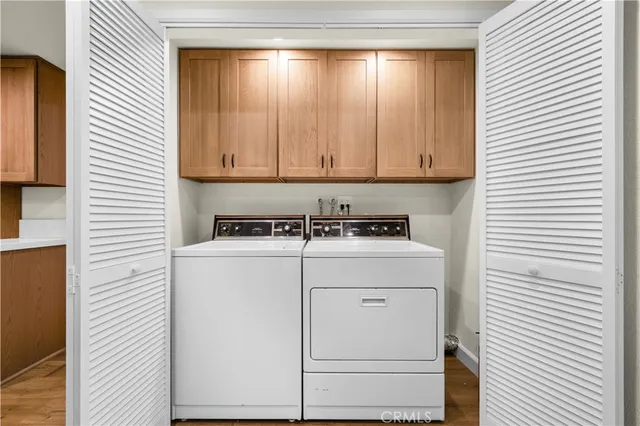 a view of storage and utility room with washer and dryer