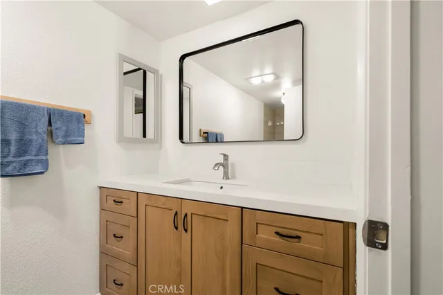 a bathroom with a double vanity sink and mirror