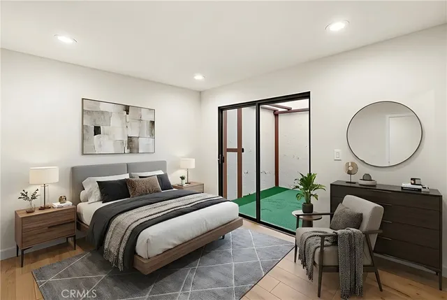 a bedroom with bed and a mirror