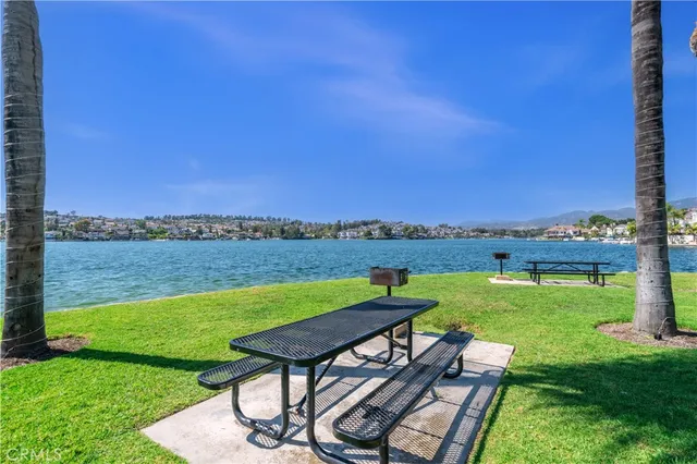 a view of a lake with couches and city view