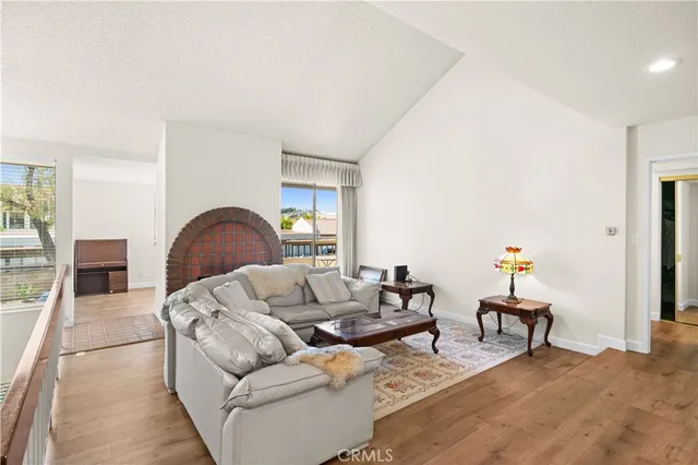 a living room with furniture and a lamp with potted plants