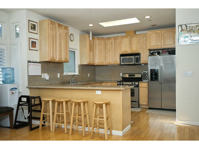 637 Hickey Boulevard Pacifica, CA 94044 - Photo 14 of 15 a kitchen with stainless steel appliances granite countertop a stove a sink dishwasher a refrigerator and a microwave