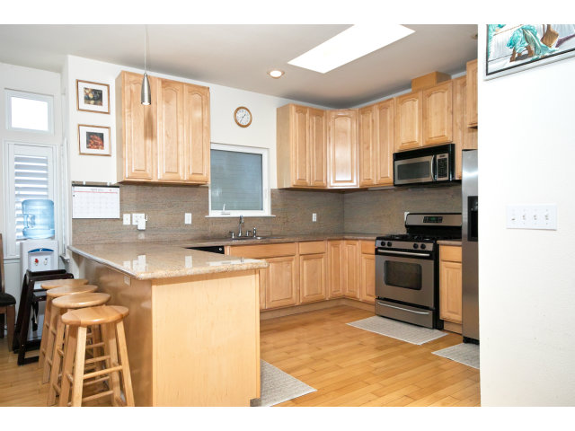 637 Hickey Boulevard Pacifica, CA 94044 - Photo 2 of 15 a kitchen with stainless steel appliances granite countertop a stove a sink and a microwave