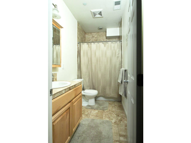637 Hickey Boulevard Pacifica, CA 94044 - Photo 7 of 15 a bathroom with a granite countertop toilet a sink and a mirror