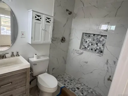 a bathroom with a bathtub and a shower