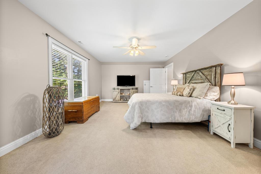 217 Maret Road Townville, SC 29689 - Photo 26 of 35 Well-lit sleeping quarters featuring soft carpeted flooring and a convenient ceiling fan for comfort.