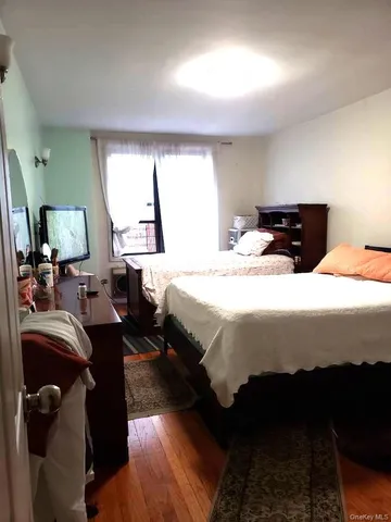 a bedroom with double bed and a window