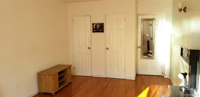 a view of a room with wooden floor