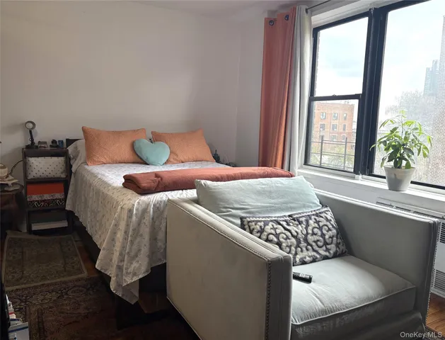 a bed sitting in a bedroom next to a window