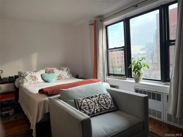 a bedroom with a bed and windows