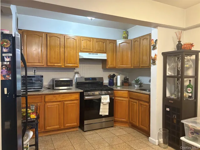 a kitchen with stainless steel appliances granite countertop a stove sink and cabinets