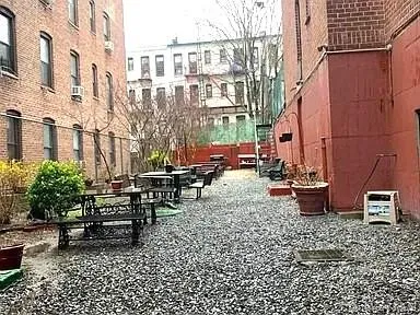 a view of a patio with a table and chairs