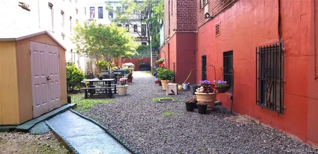 a view of two chairs in a backyard