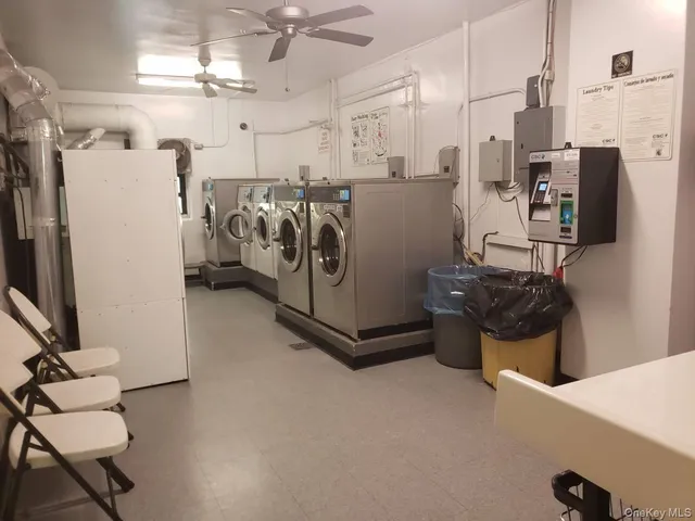 a utility room with multiple dryer and washer