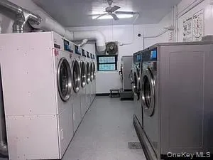 a utility room with multiple dryer and washer