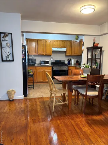 a kitchen with stainless steel appliances a stove a sink and a refrigerator