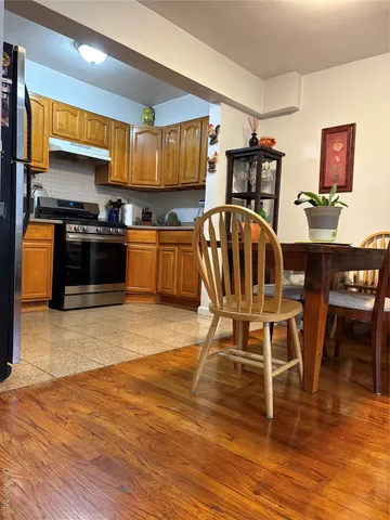a view of a kitchen with dining table and chairs