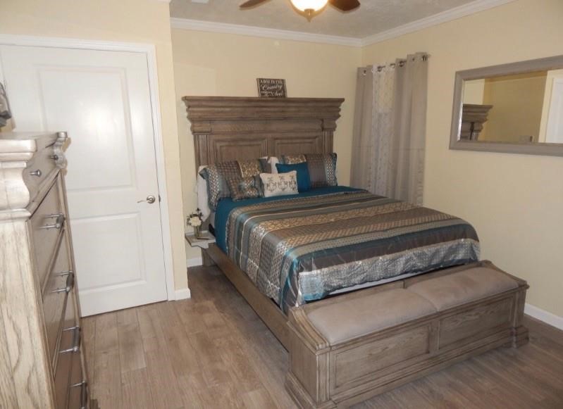 8821 Woodruff Street Houston, TX 77012 - Photo 11 of 20 a bedroom with a bed and a chandelier