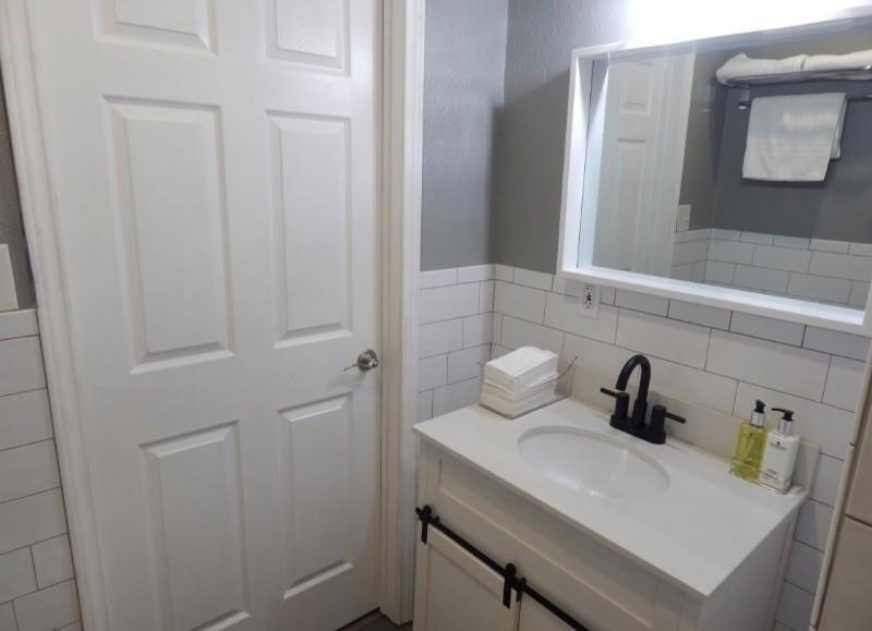 8821 Woodruff Street Houston, TX 77012 - Photo 17 of 20 a bathroom with a sink a toilet and mirror