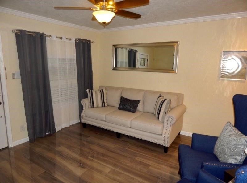 8821 Woodruff Street Houston, TX 77012 - Photo 2 of 20 a living room with furniture and a wooden floor
