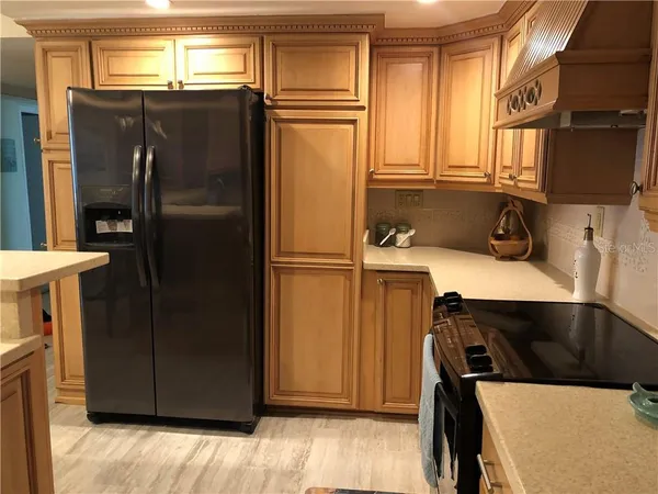 a kitchen with a refrigerator and a sink