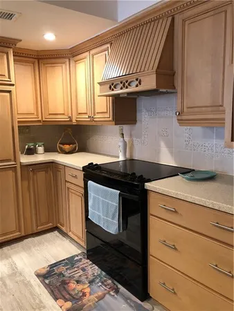a kitchen with a sink stove and cabinets