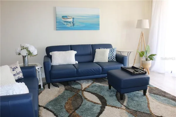 a living room with furniture and a potted plant