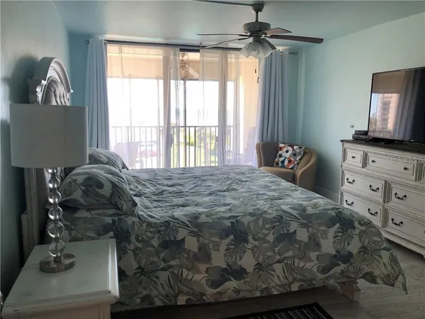 a bedroom with a bed and a mirror