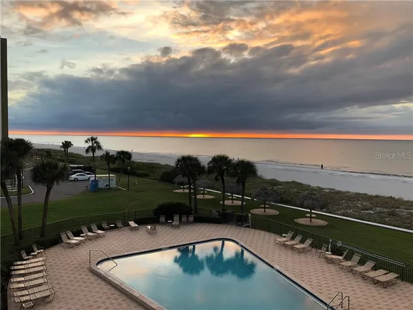 a view of a swimming pool and lounge chair