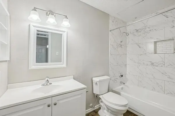 a bathroom with a sink toilet and shower