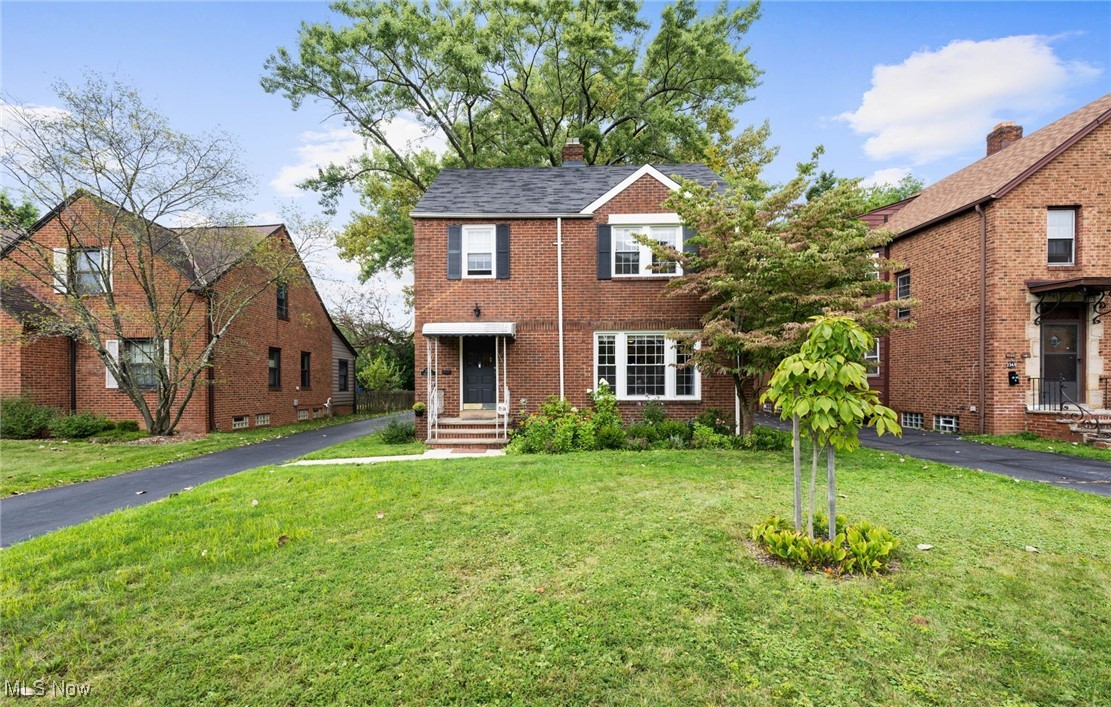 View of front of property featuring brick siding, and a  front yard
