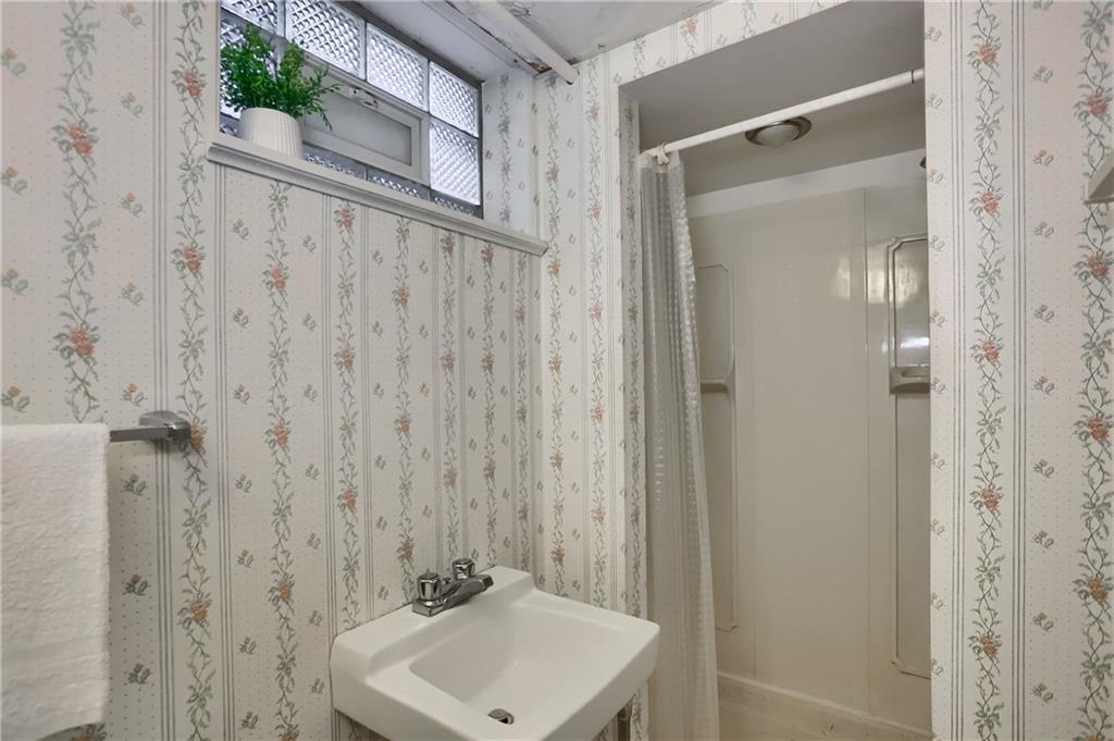 104 Linda Vista Road Sewickley, PA 15143 - Photo 31 of 50 a bathroom with a sink a mirror and shower