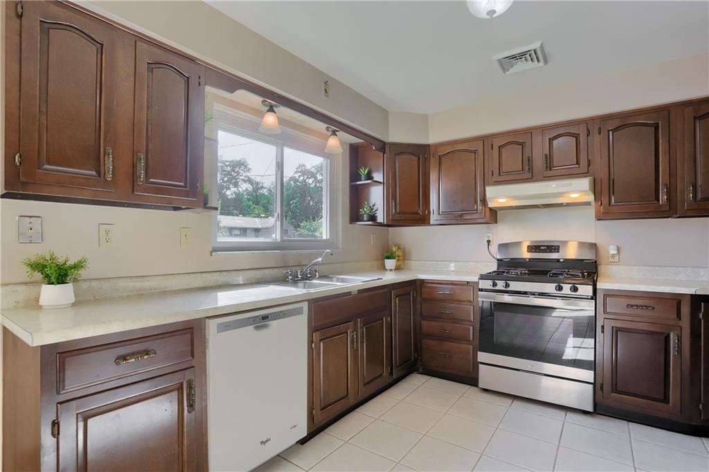 104 Linda Vista Road Sewickley, PA 15143 - Photo 10 of 50 a kitchen with stainless steel appliances granite countertop a sink stove and refrigerator