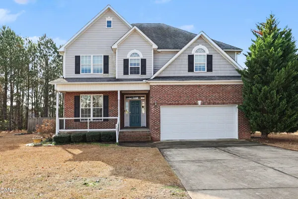 a front view of a house with a yard and garage