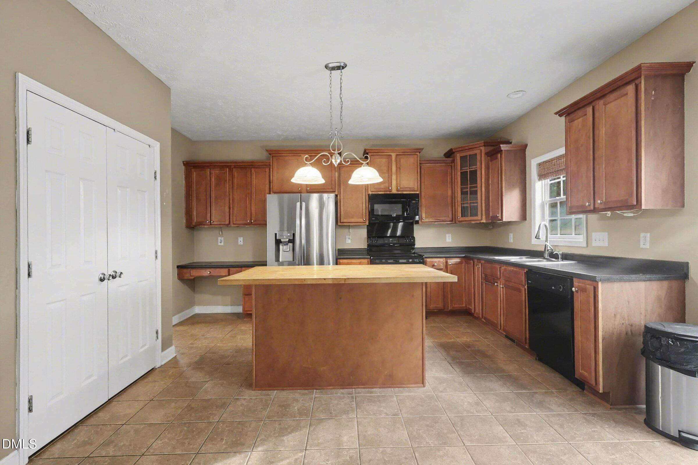 615 Lenoir Drive Spring Lake, NC 28390 - Photo 13 of 39 a view of a kitchen with kitchen island granite countertop wooden cabinets