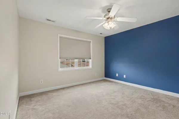 a spacious bathroom with a double vanity sink and a window