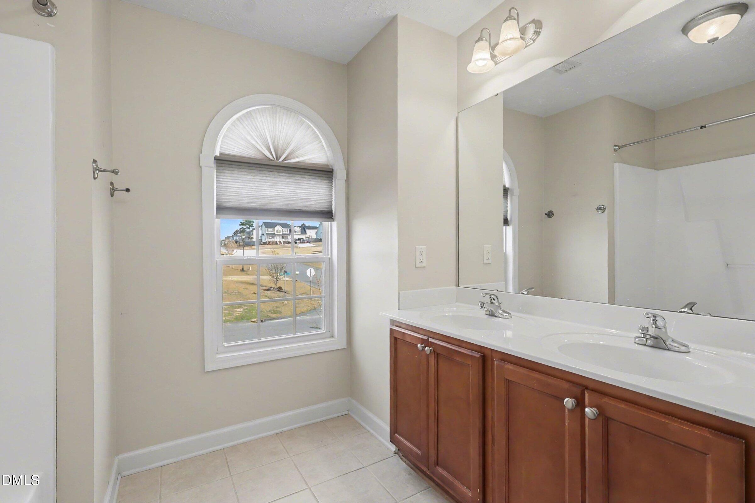 615 Lenoir Drive Spring Lake, NC 28390 - Photo 20 of 39 a spacious bathroom with a double vanity sink and a window