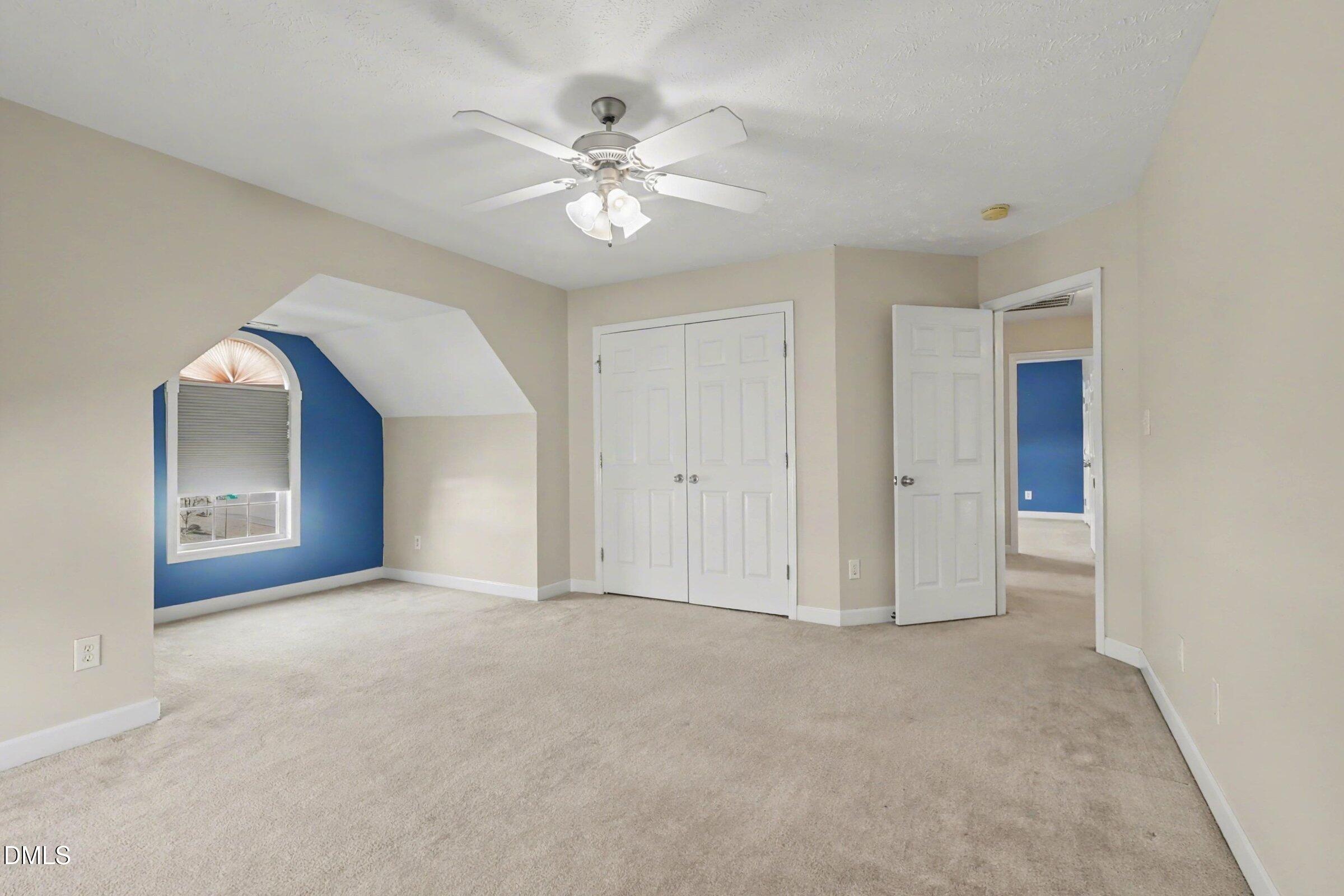 615 Lenoir Drive Spring Lake, NC 28390 - Photo 21 of 39 a view of an empty room with a chandelier fan