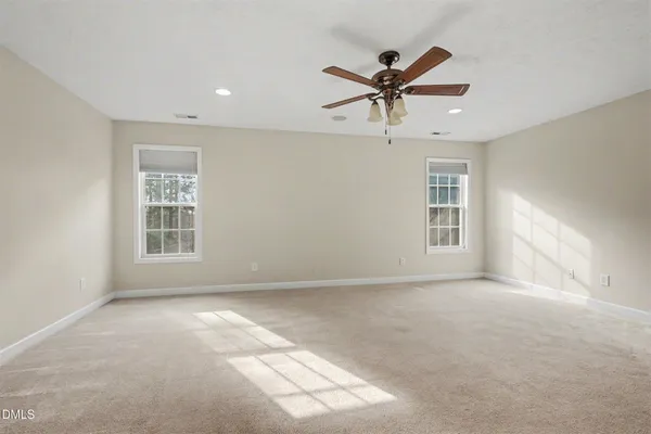 a spacious bedroom with a bed and couch