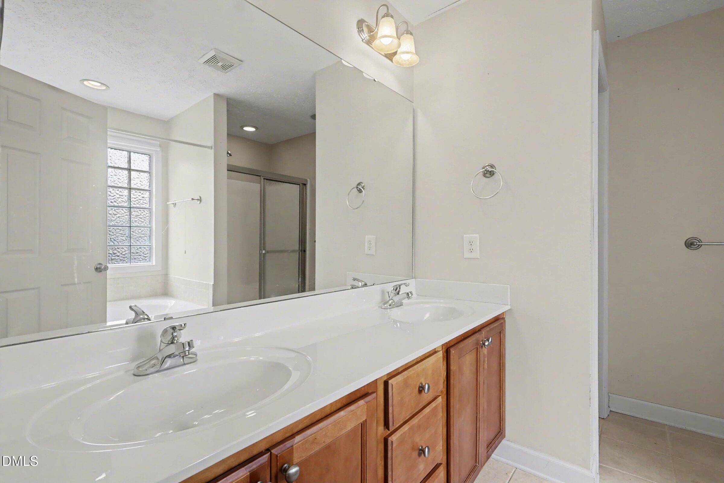 615 Lenoir Drive Spring Lake, NC 28390 - Photo 32 of 39 a bathroom with a sink double vanity and a mirror