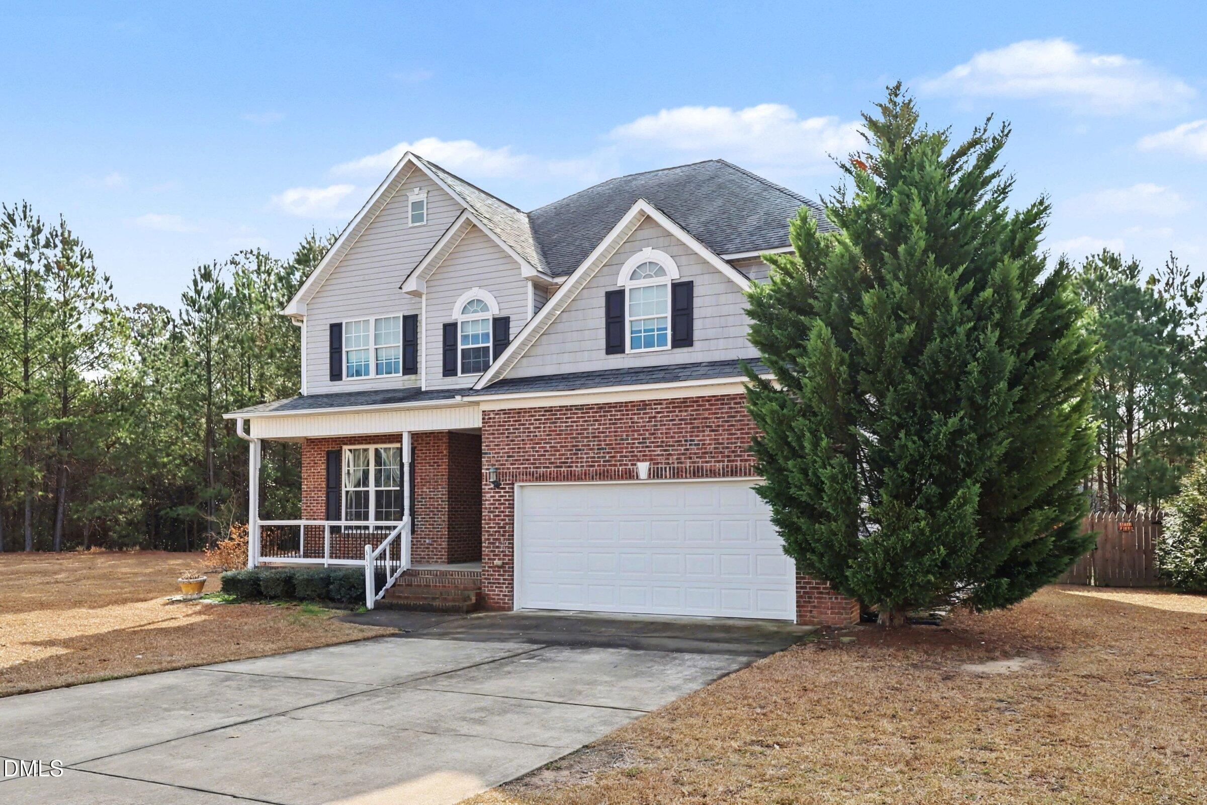 615 Lenoir Drive Spring Lake, NC 28390 - Photo 3 of 39 a front view of a house with a yard and garage